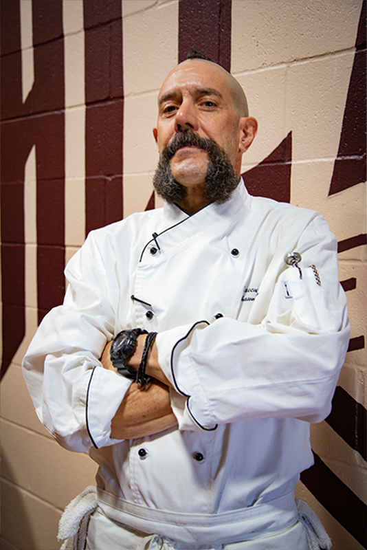 Chef Shawn Weinbender standing inside of Alexandria Brewing Company.